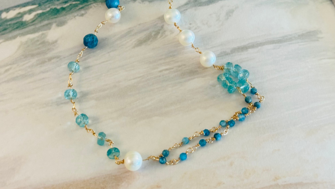 Necklace with blue and white beads on a wooden surface