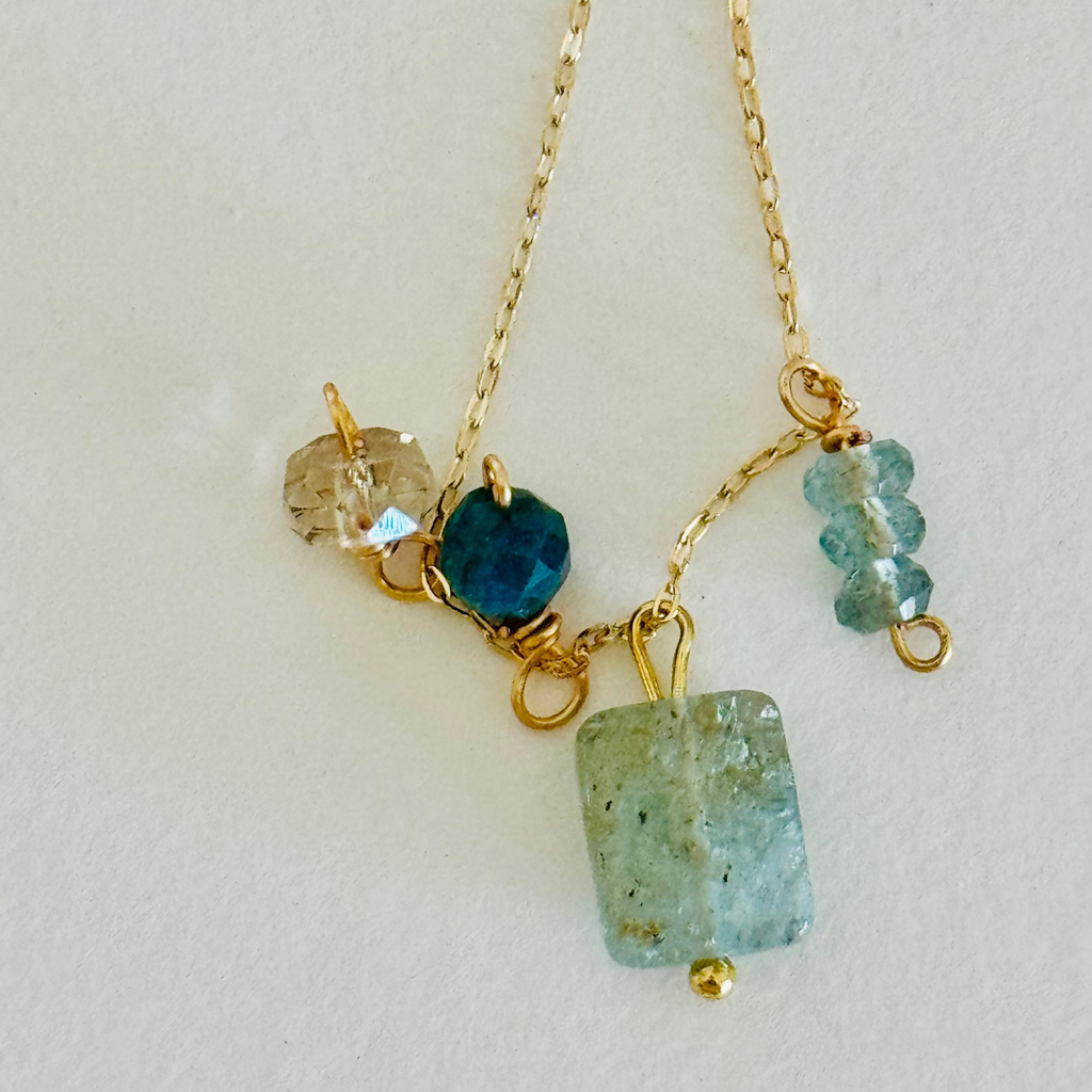 Aventurine, Apatite, Mystic Topaz, and Gold Quartz stones (one of each) on 14k gold-filled wire chain. Blue and green hues in the sones and translucent so the wiring can ever so slightly be seen through, creating contrast and warmth.