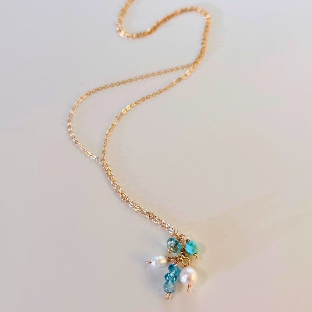 Mystic Blue Topaz Cluster Necklace on white background. 
