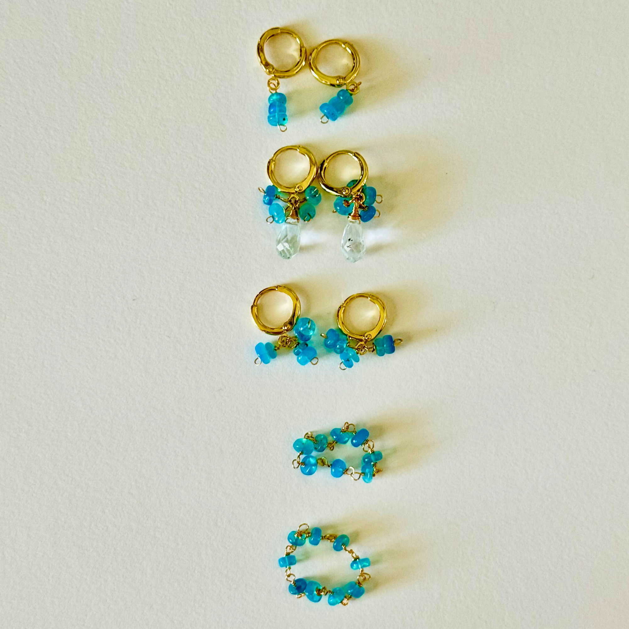 Gold and turquoise beaded earrings on a light background