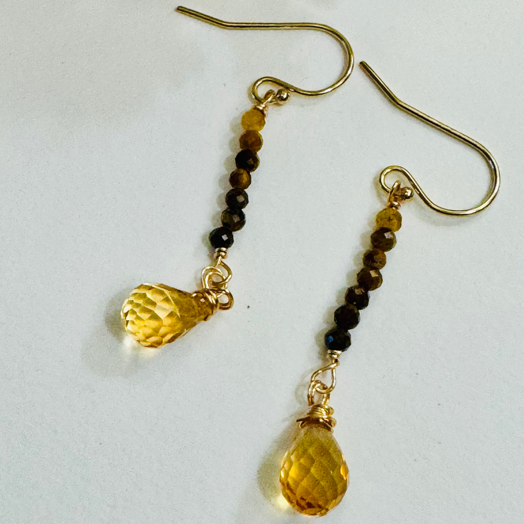 Genuine tiger eye and citrine gemstones in yellow and brown hues on 14k gold filled drop strand earrings displayed against a white background.